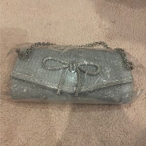 Silver Sparkle Evening Clutch with Chain Strap and Rhinestone Bow and Trim